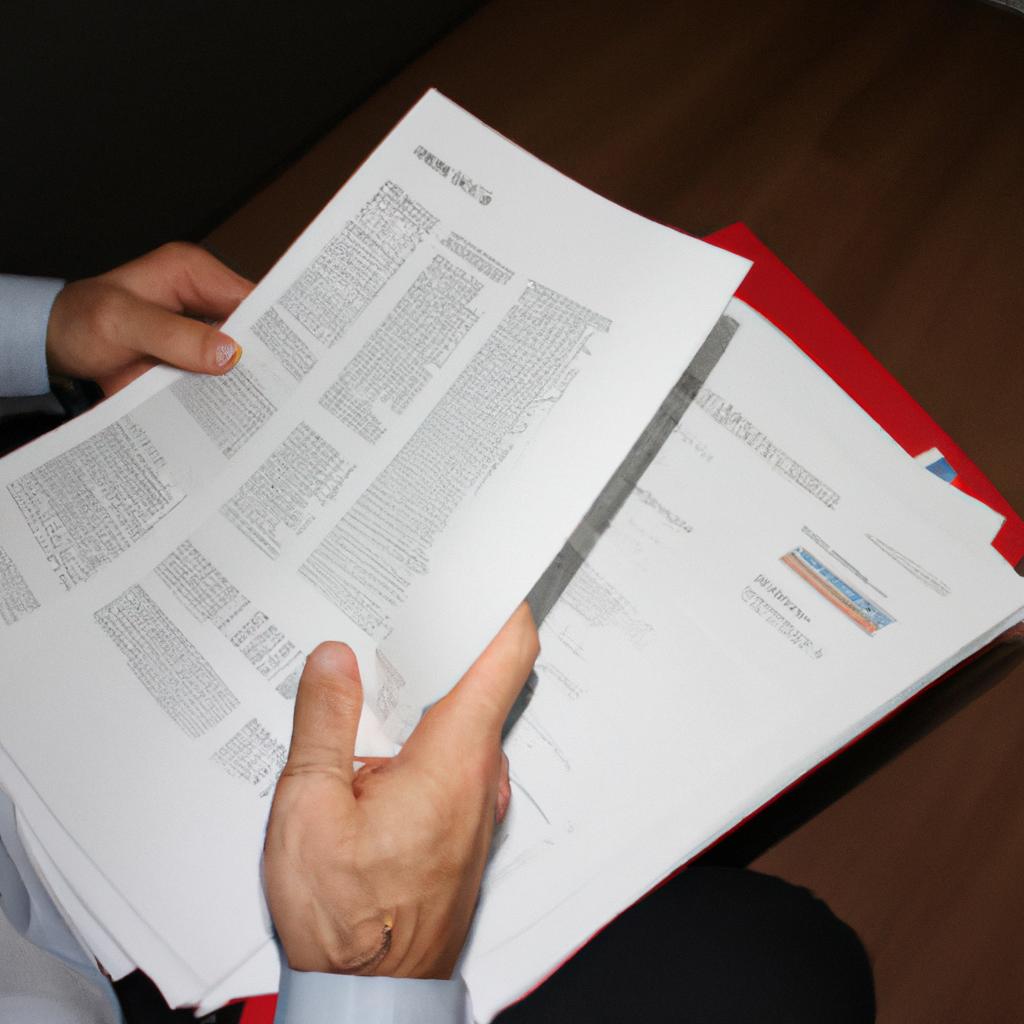 Person reading financial documents, organizing